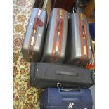 Three Samsonite suitcases with mid brown leather handles and trim together with a black Antler