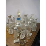 A good collection of silver topped and silver collared cut glass scent bottles and others Location: