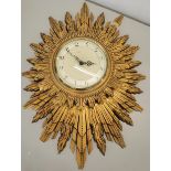 A Smiths mid 20th century gilt Sunburst clock with a later electric movement