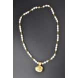 A singe string pearl necklace with gold and green beads at intervals, with an 18ct gold ball clasp