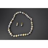 A singe string of Samuel Jones pearl necklace with dark, medium, light grey, pale golden and cream