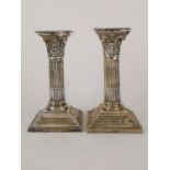 A matched pair silver Corinthian column candle sticks by George Nathan & Ridley Hayes, Chester 1898,