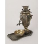 An Iranian silver coloured metal working ornamental samovar 23 cm high with stand and matching bowl,