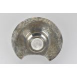 A 19th century Middle Eastern silver bleeding/shaving bowl, with a broad rim and shaped dish,