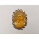 A Continental 14ct gold ring set with large citrine surrounded by seed pearls, size O