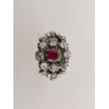 A 19th century gold ring set with a ruby surrounded by eight old cut diamonds, size O