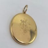 A 18ct gold locket, engraved to the front with a monogram and stamped 18 to back, total weight 18.6g