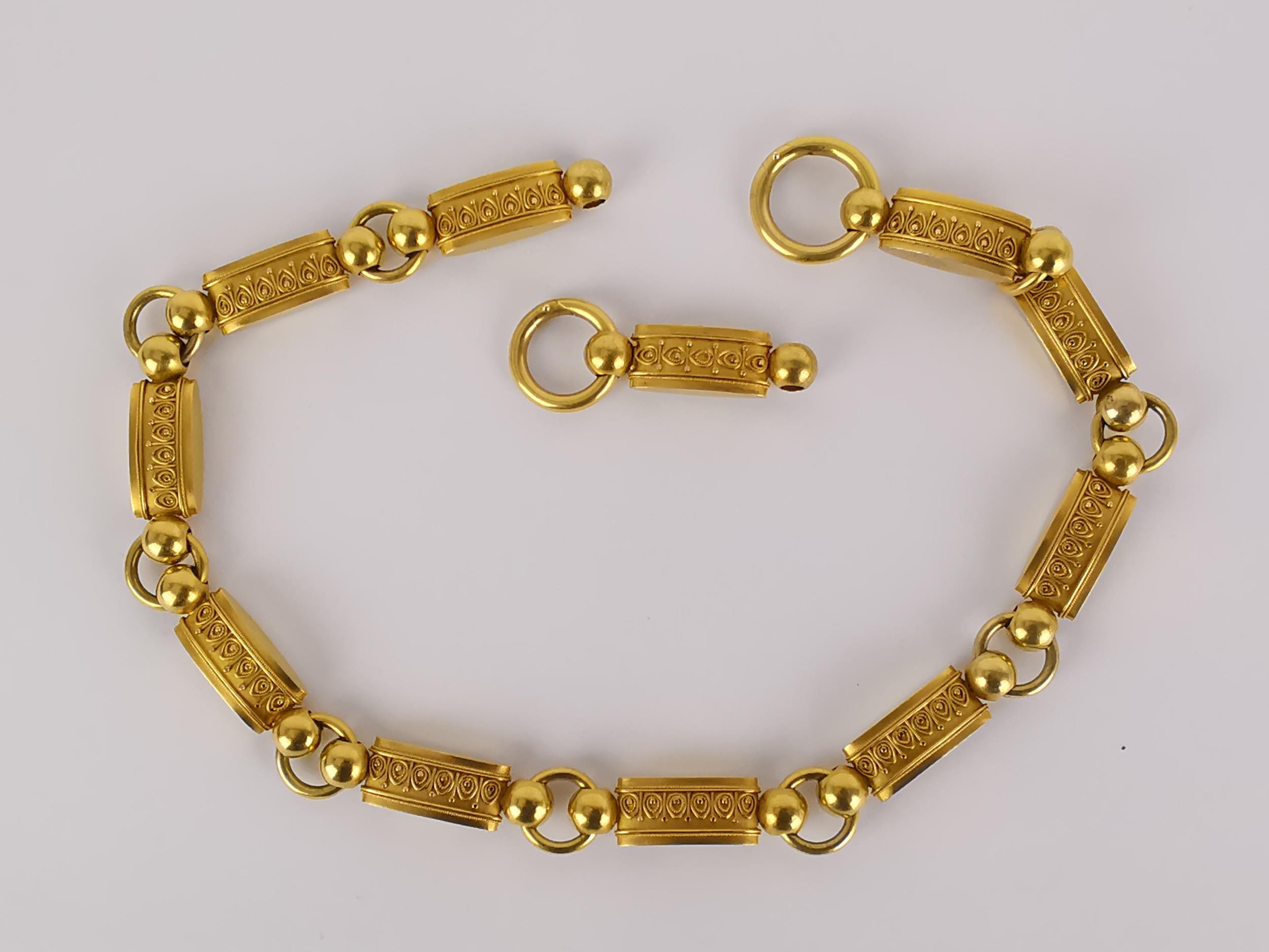 A Continental gold necklace, the eleven oblong sections with geometric design, connected by hoop