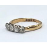 An 18ct gold ring with five inset graduating diamonds, central diamond approx 3.3mm, size J 1/2, 2.