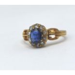 A 18ct gold cluster ring having a central sapphire surrounded by 10 diamonds, sapphire 4.7mm other