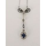An Art Nouveau style white gold pendant set with a sapphire and diamonds, unmarked, tested as 14ct