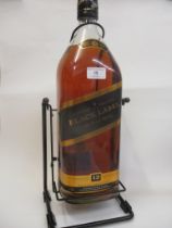 A large 4.5 litre bottle of Johnnie Walker Black Label on a metal stand
