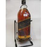 A large 4.5 litre bottle of Johnnie Walker Black Label on a metal stand