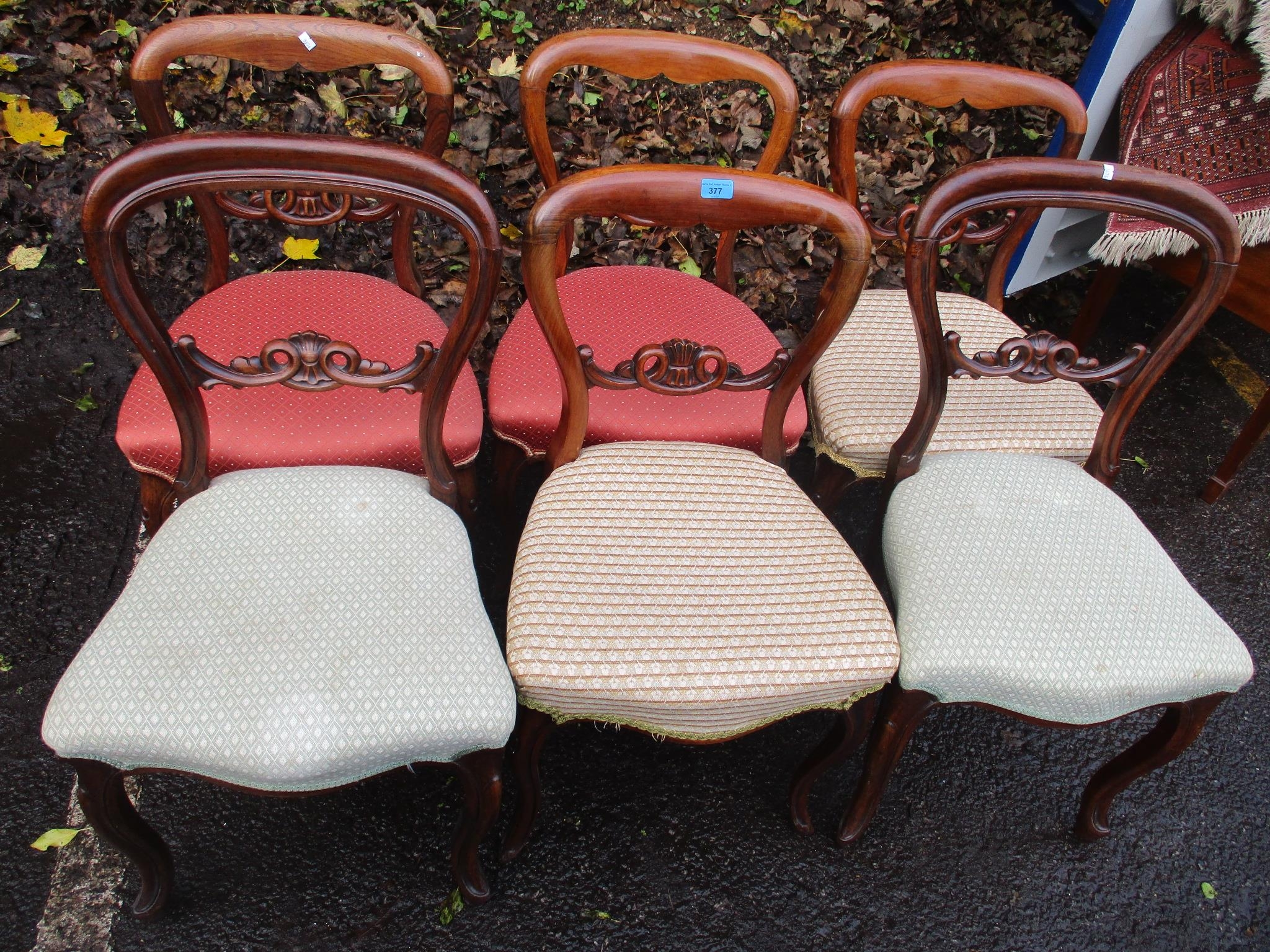 A matched set of six Victorian rosewood balloon back dining chairs on cabriole legs