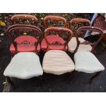 A matched set of six Victorian rosewood balloon back dining chairs on cabriole legs