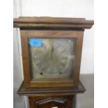 An oak cased granddaughter long case clock, 8-day with Roman silvered dial, plinth base on bracket