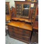 A Victorian Art Nouveau walnut dressing table having a swing mirror flanked by two folding mirrors