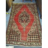 A Persian design rug with a central medallion Location: