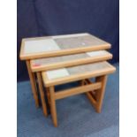 A retro nest of light oak and stone tile topped tables Location: A1M