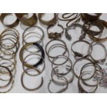 Eastern white metal and silver and other metallic bangles to include ornate bangles with snake,