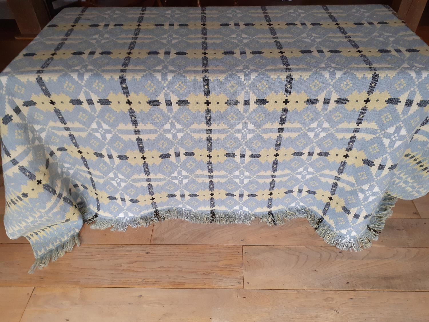 A vintage Welsh reversible woollen blanket having a cornflower blue ground to one side with