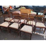 A set of eight early 19th century mahogany dining chairs with tapestry seats and on square legs, two