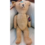 A 1920s wood wool filled teddy bear, possibly French, with blonde mohair, clear glass eyes and