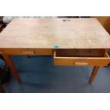 A mid 20th century oak teacher's desk with two central drawers and a sliding inkwell section, 75cm h