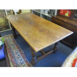 An early 20th century oak refectory dining table having turned legs and H framed stretcher, 77cm h x