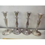 Two pairs of silver plated candlesticks to include one pair having baluster columns with floral