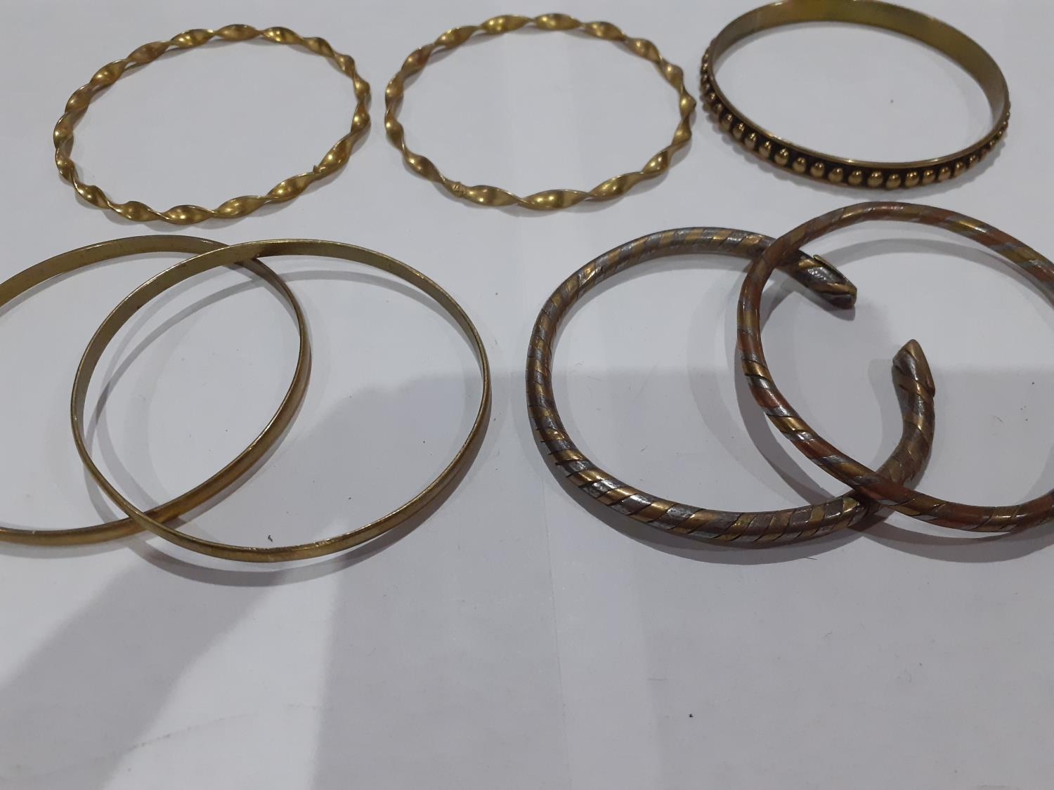 Eastern white metal and silver and other metallic bangles to include ornate bangles with snake, - Image 5 of 12