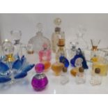 A collection of decorative empty glass perfume bottles to include a silver collared example and