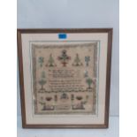 An 1824 sampler worked by Mary Grace Slatter, framed, 33cm x 38 cm.