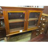 An early 20th century walnut fire surround with a mounted cabinet above, together with a Chinese
