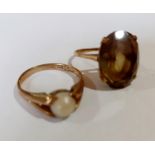 Two 9ct gold rings, one having a smoky grey cabochon, 3.3g and the other having a central pearl,