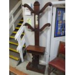 A Victorian mahogany hall stand with central mirror flanked by four hanging hooks, glove box below