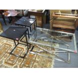 A modern chrome and glass topped coffee table 41.5cm x 96.5cm, together with a pair of black