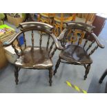 A pair of dark stained Captain armchairs having turned spindle supports Location: