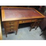 A late 19th/early 20th century Cooke's Finsbury Ltd, walnut desk having a red leather topped
