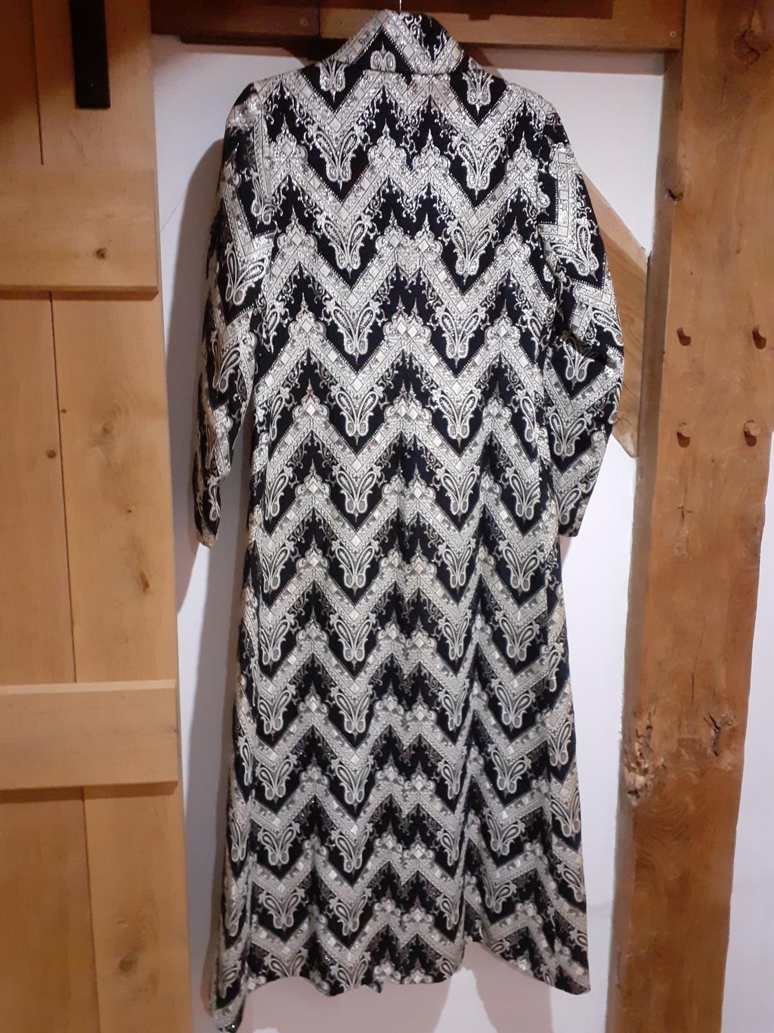 A Retro full length coat having a black ground with white chevron design, silver coloured thread - Image 3 of 4