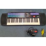 A late 20th century electronic Yamaha piano keyboard, and a collection of CDs, DVDs and tapes to