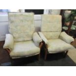 A pair of late 20th century Ercol light elm armchairs with loose floral cushions Location: BWR