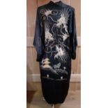 A vintage Chinese black silk kimono with images of wind dragons to the rear and outline swirls to