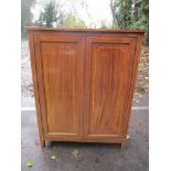 An early 20th century mahogany and box wood inlaid, two door dressing chest having a single cupboard