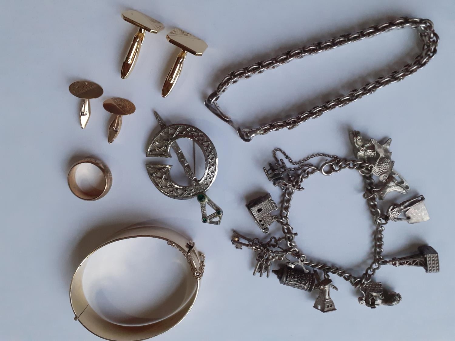 Costume jewellery to include a gold plated bangle, a silver Scottish brooch, a gold plated wedding