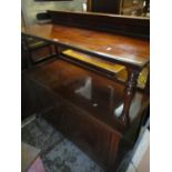 An early 20th century Maple & Co mahogany buffet stand having two tiers with a raised back and two