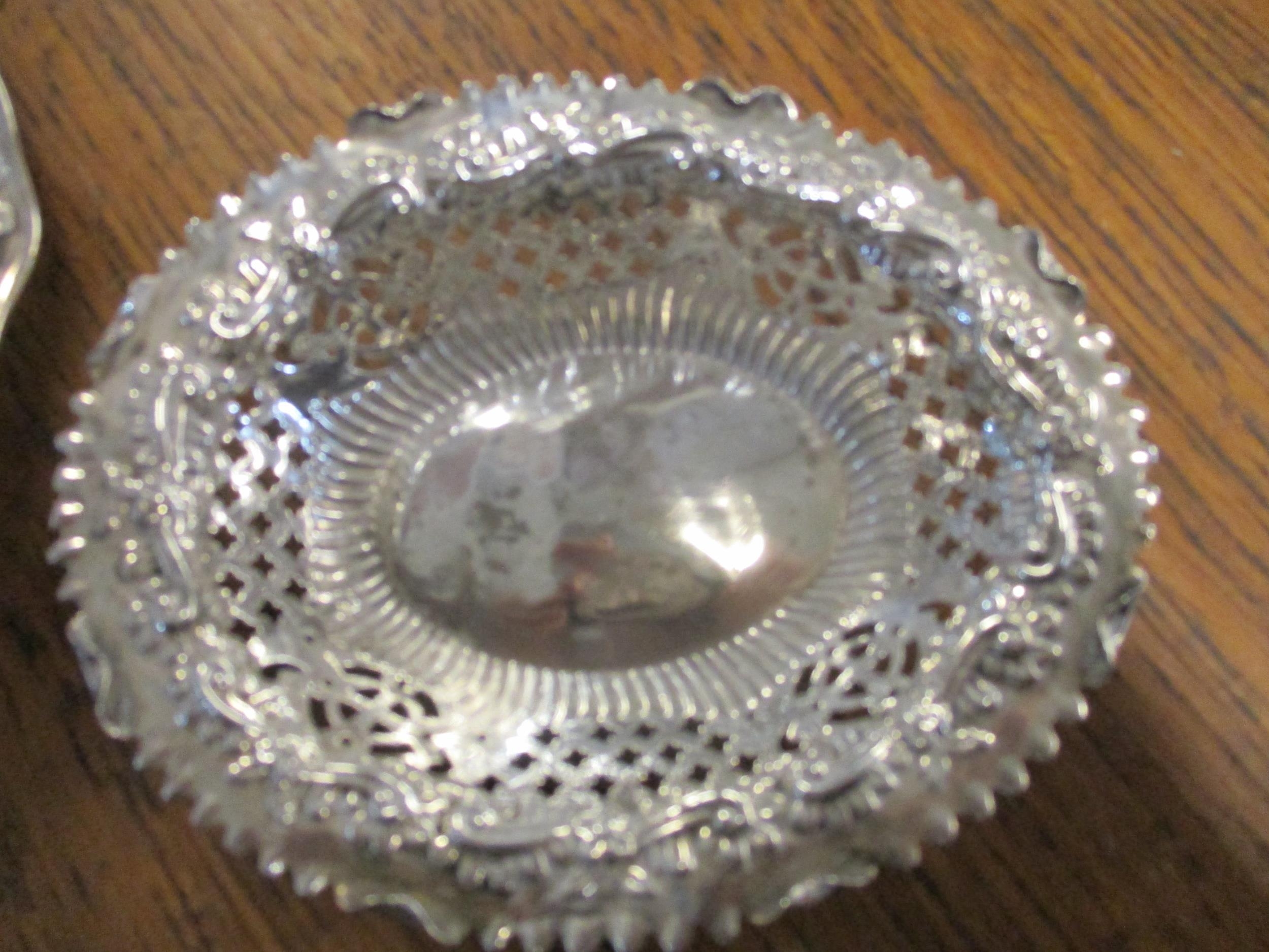 A 925 silver dish of octagonal form, repousse decorated with flower heads and leaves and a pair of - Image 3 of 3