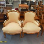 A pair of French style reproduction beech armchairs on short cabriole legs