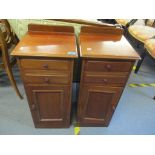 A pair of Victorian mahogany bedside cabinets having two drawers above a single cupboard door