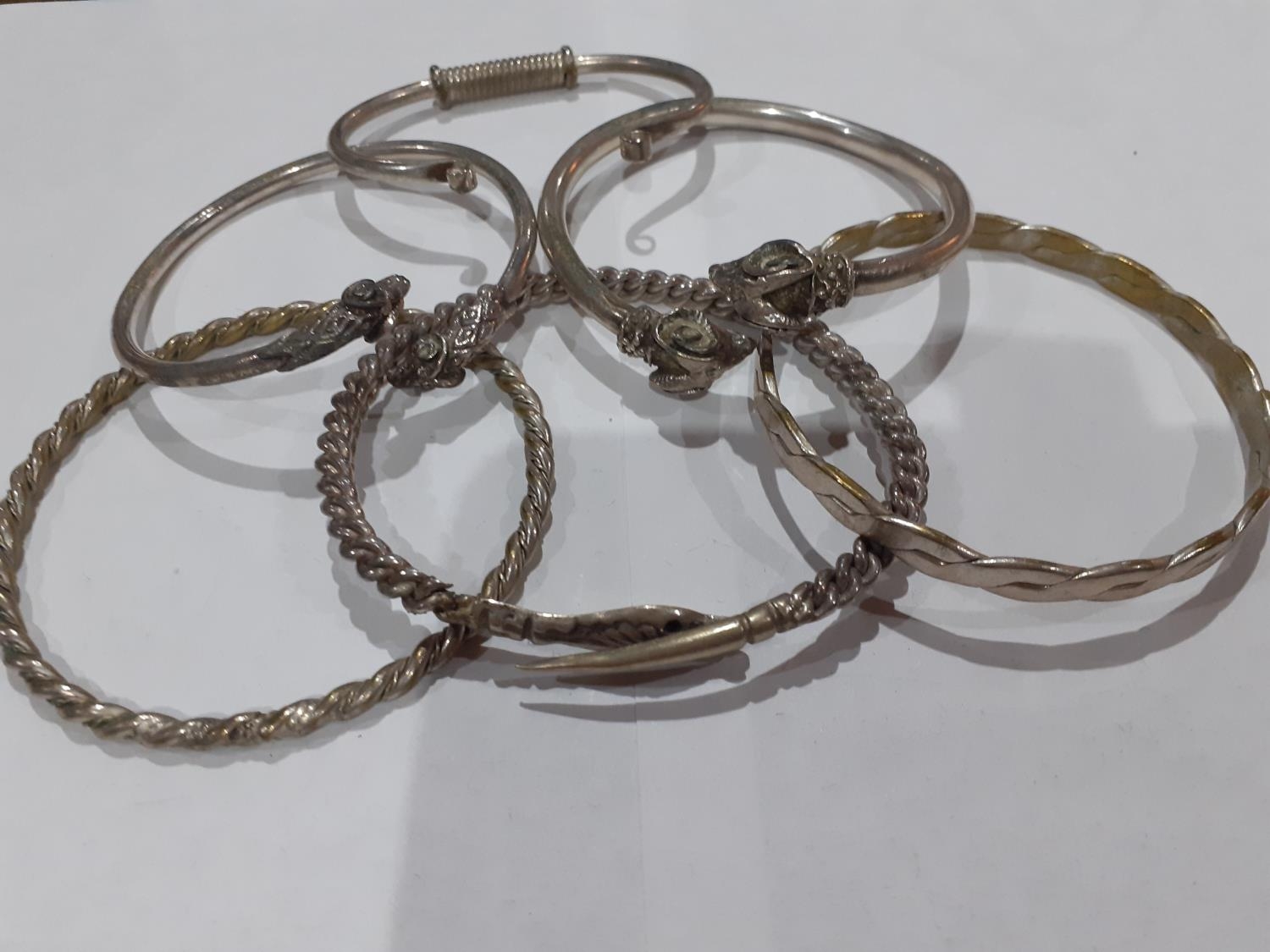 Eastern white metal and silver and other metallic bangles to include ornate bangles with snake, - Image 4 of 12
